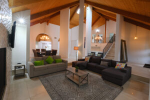 Luxury living room with high ceilings and exposed wood beams photographed in San Diego