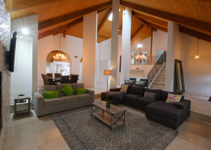 Luxury living room with high ceilings and exposed wood beams photographed in San Diego