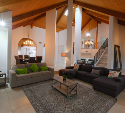 Luxury living room with high ceilings and exposed wood beams photographed in San Diego