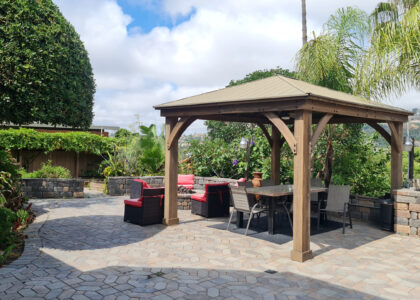 Luxury backyard patio with wooden gazebo and outdoor seating area photographed in San Diego