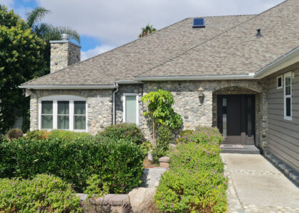 Front entrance of stone facade home photographed in San Diego