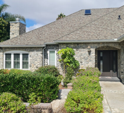 Front entrance of stone facade home photographed in San Diego